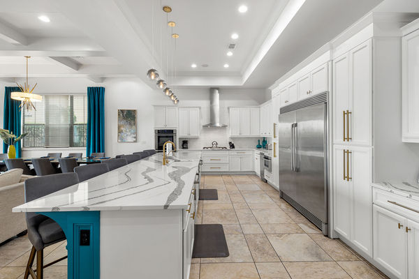 The kitchen features stainless steel appliances, custom cabinetry, breakfast bar seating for 5 and granite counters