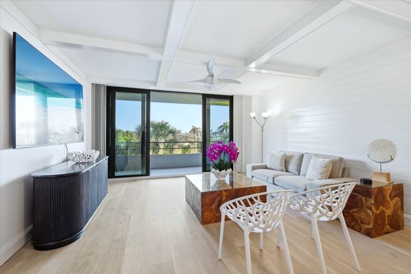 Bright, open living space with balcony access and 85-inch Smart TV