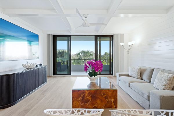 Bright, open living space with balcony access and 85-inch Smart TV