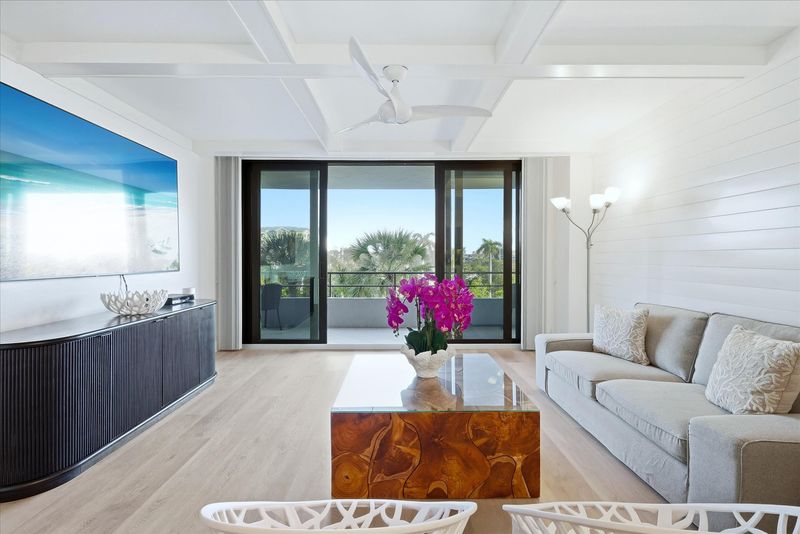 Bright, open living space with balcony access and 85-inch Smart TV