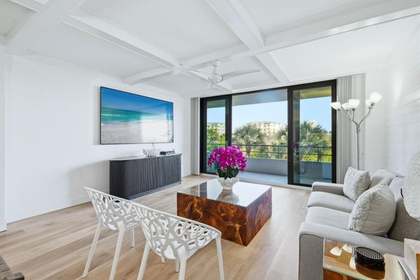 Bright, open living space with balcony access and 85-inch Smart TV