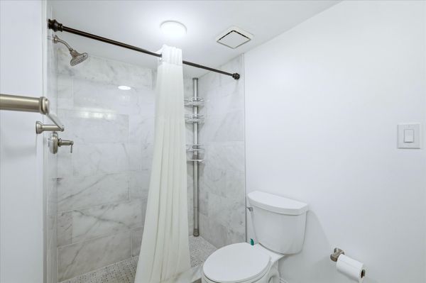 Attached bathroom with walk-in shower and double vanities