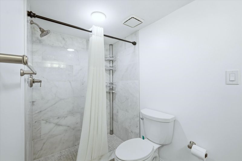 Attached bathroom with walk-in shower and double vanities