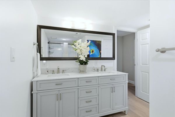 Attached bathroom with walk-in shower and double vanities