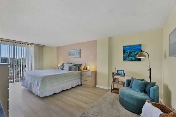 Primary bedroom with king bed ensuite, balcony access, 42-inch TV, crib, cell phone docking stations