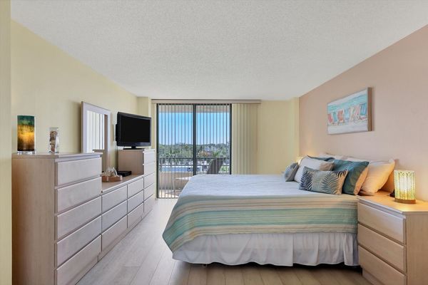 Primary bedroom with king bed ensuite, balcony access, 42-inch TV, crib, cell phone docking stations