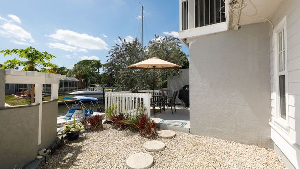 Patio area in the back of the house overlooking the canal. There is an additional patio area further below that belongs to the upstairs neighbor.