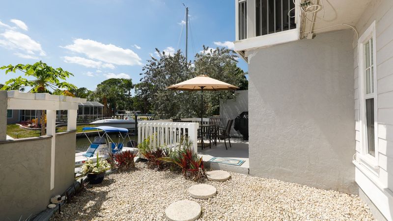 Patio area in the back of the house overlooking the canal. There is an additional patio area further below that belongs to the upstairs neighbor.