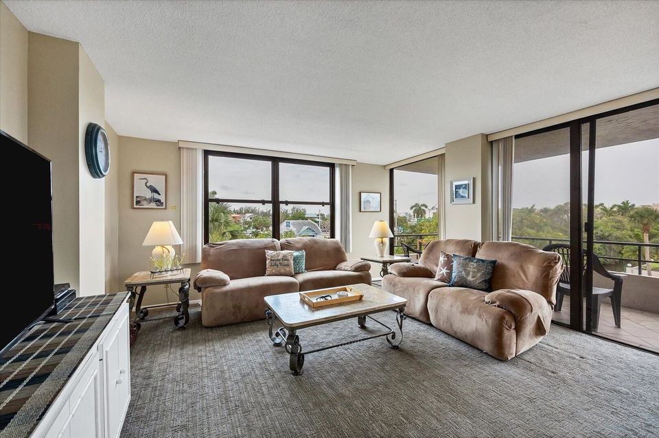 Living room features comfy sofas and 55-inch Smart TV