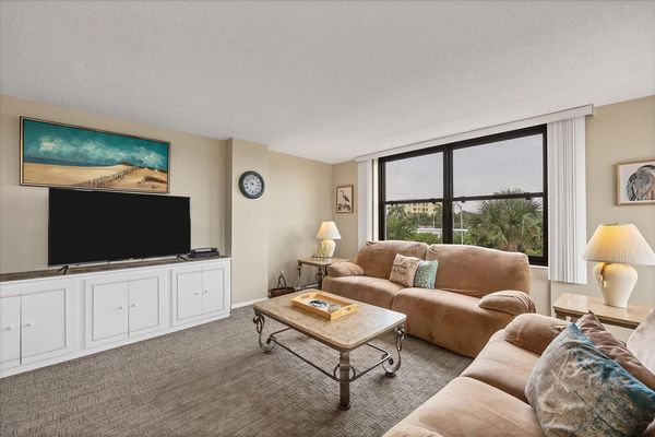 Living room features comfy sofas and 55-inch Smart TV