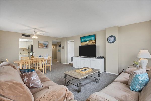 Living room features comfy sofas and 55-inch Smart TV