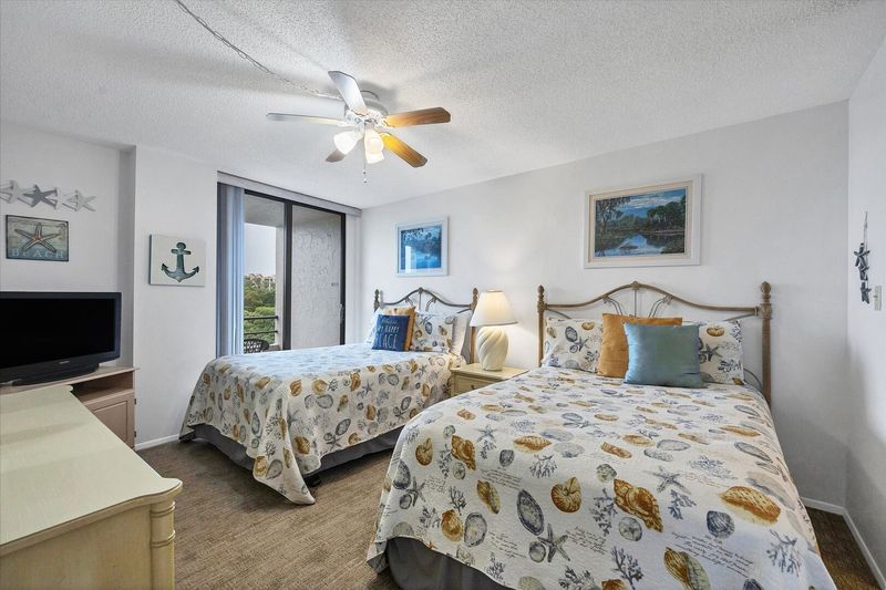 Guest Bedroom Features 2 Double Beds, Balcony Acces, Attached Bathroom, and 32-inch TV