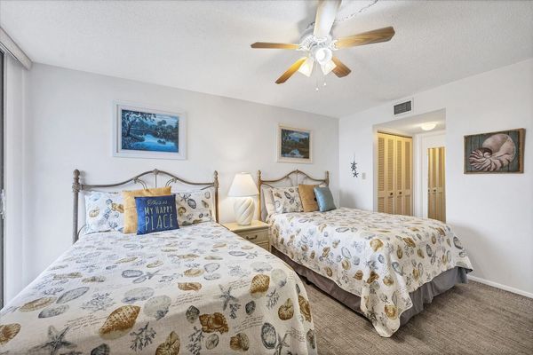 Guest Bedroom Features 2 Double Beds, Balcony Acces, Attached Bathroom, and 32-inch TV