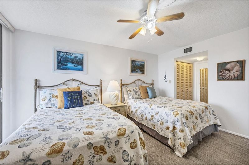 Guest Bedroom Features 2 Double Beds, Balcony Acces, Attached Bathroom, and 32-inch TV