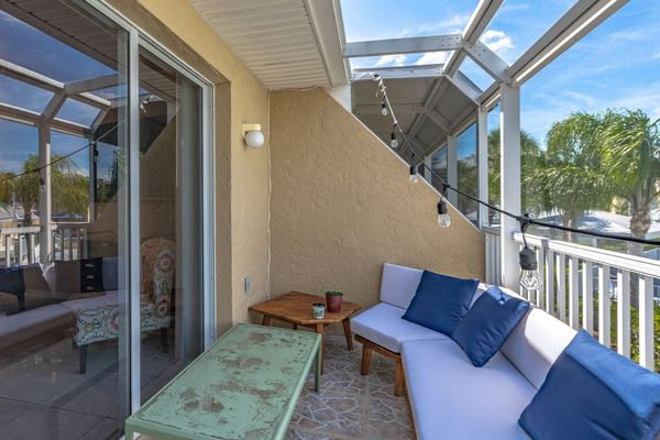 Private Patio with screened-in enclosure off the living room overlooking the docks and pools in the community