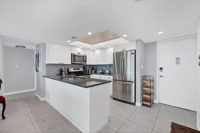 Beautifully updated, fully-equipped kitchen overlooking living room/dining room