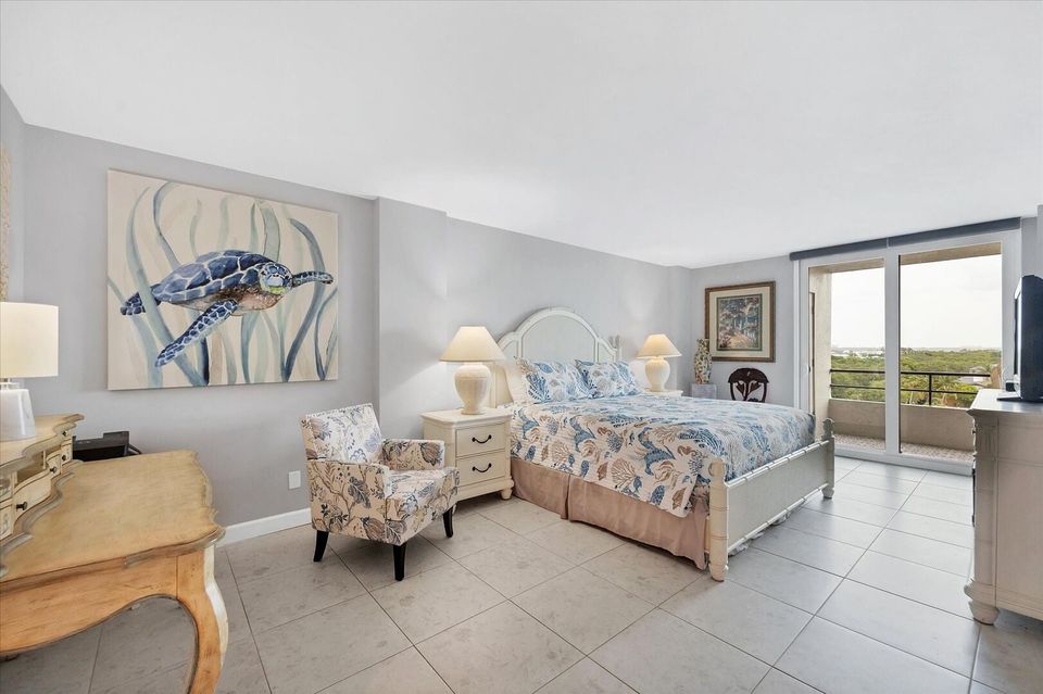Primary bedroom with king bed, desk, en suite, balcony access, and 43-inch Smart TV