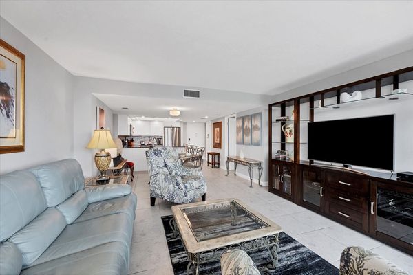 Bright, open living space. Living room features 65-inch Smart TV.