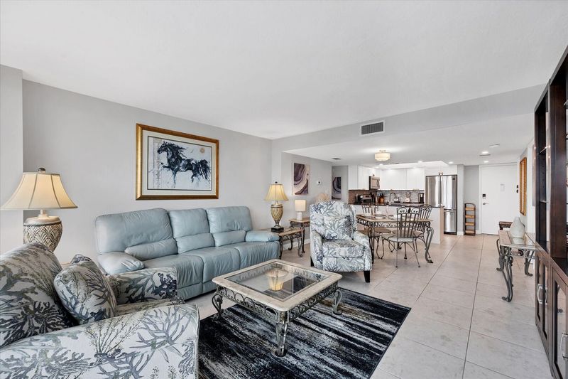 Bright, open living space. Living room features 65-inch Smart TV.