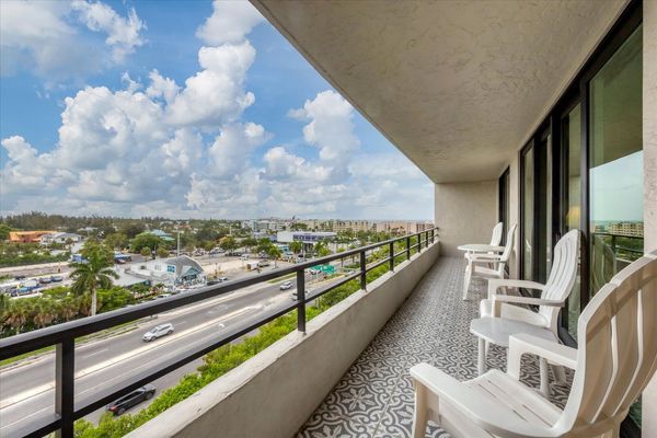 Large balcony overlooking canal with view of south Siesta Key, the Intracoastal Waterway and Gulf of Mexico