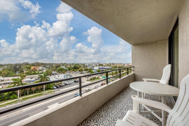 Large balcony overlooking canal with view of south Siesta Key, the Intracoastal Waterway and Gulf of Mexico
