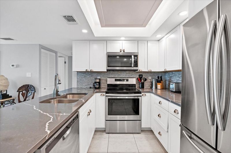 Beautifully updated, fully-equipped kitchen overlooking living room/dining room