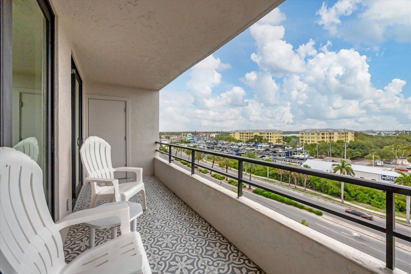 Large balcony overlooking canal with view of south Siesta Key, the Intracoastal Waterway and Gulf of Mexico