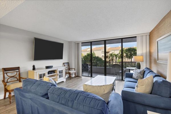 Living Room with lots of comfy seating, 75-inch Smart TV and balcony access