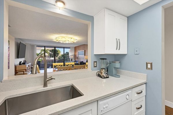 Bright, fully-equipped kitchen overlooking dining room / living room