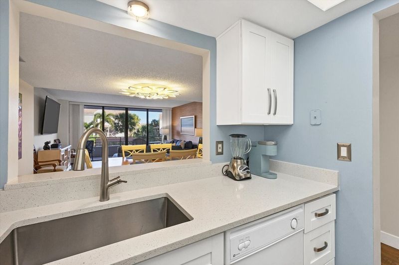 Bright, fully-equipped kitchen overlooking dining room / living room