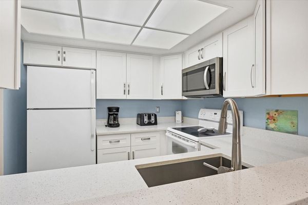 Bright, fully-equipped kitchen overlooking dining room / living room