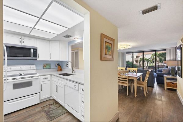 Bright, fully-equipped kitchen overlooking dining room / living room