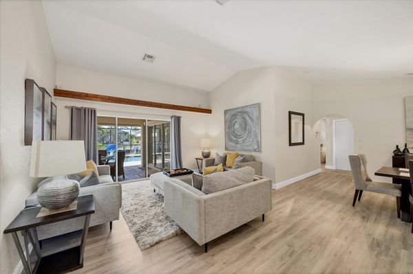 Formal living room overlooking the sparkling pool and canal beyond