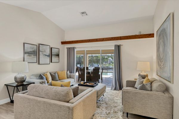 Formal living room overlooking the sparkling pool and canal beyond