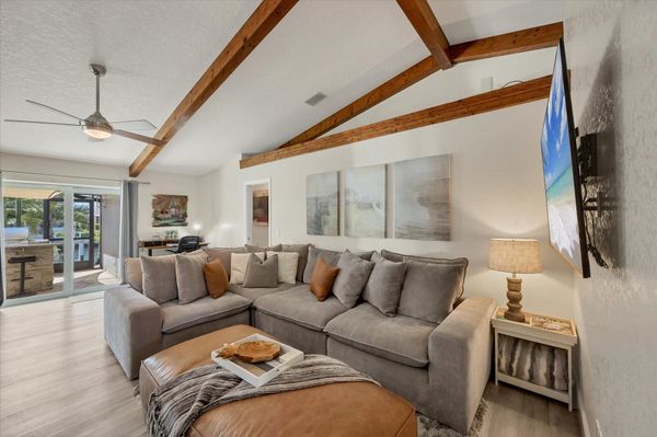 Family Room just off the kitchen with cofy sectional sofa and 65" Smart TV