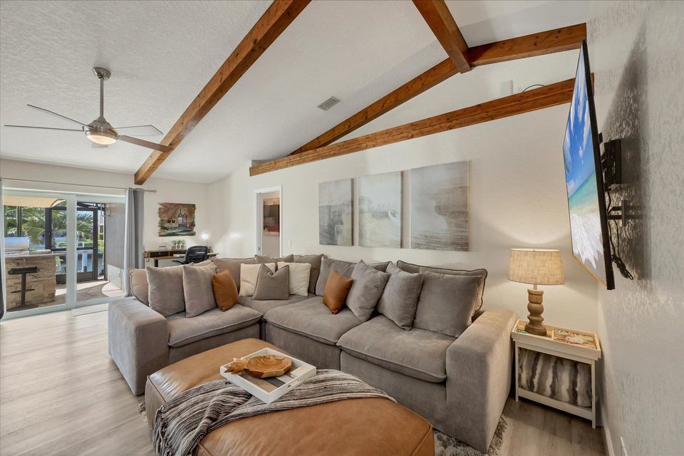 Family Room just off the kitchen with cofy sectional sofa and 65" Smart TV