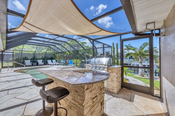Lanai BBQ grill and bar seating. Pool size: 27' x 14' 5'