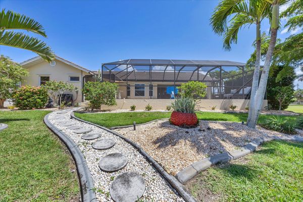 Path leading to canal and dock. Dock size: 30' x 6-1/2' with Power and Water