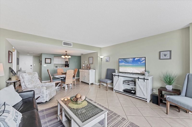 Bright, open living area with balcony access and water view