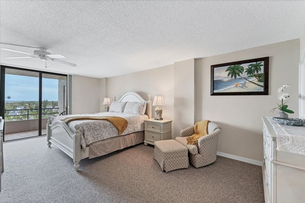 Primary bedroom with attached bathroom and balcony access