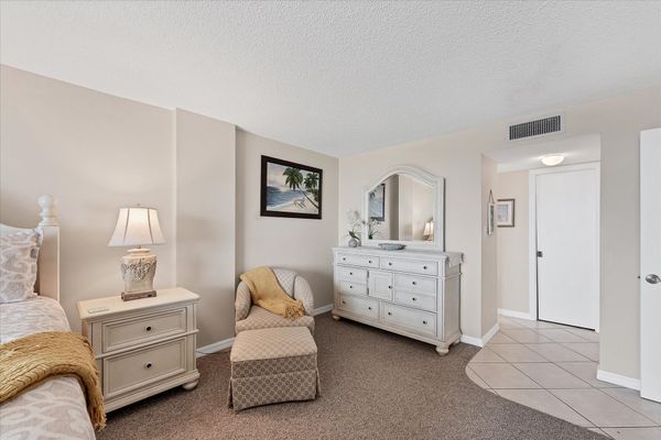 Primary bedroom with attached bathroom and balcony access