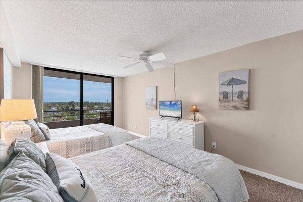 Guest bedroom with two queen beds and balcony access