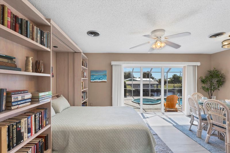 Dining room with queen Murphy bed and lanai access