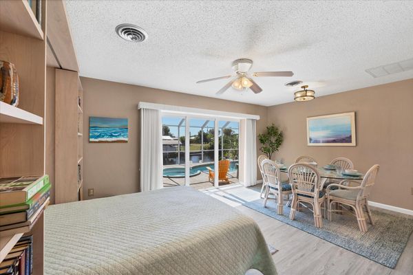 Dining room with queen Murphy bed and lanai access