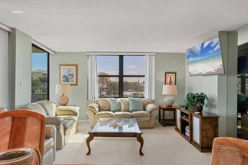 Living room/dining room combo with balcony access and view of Intracoastal Waterway
