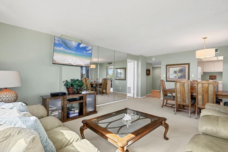 Living room/dining room combo with balcony access and view of Intracoastal Waterway