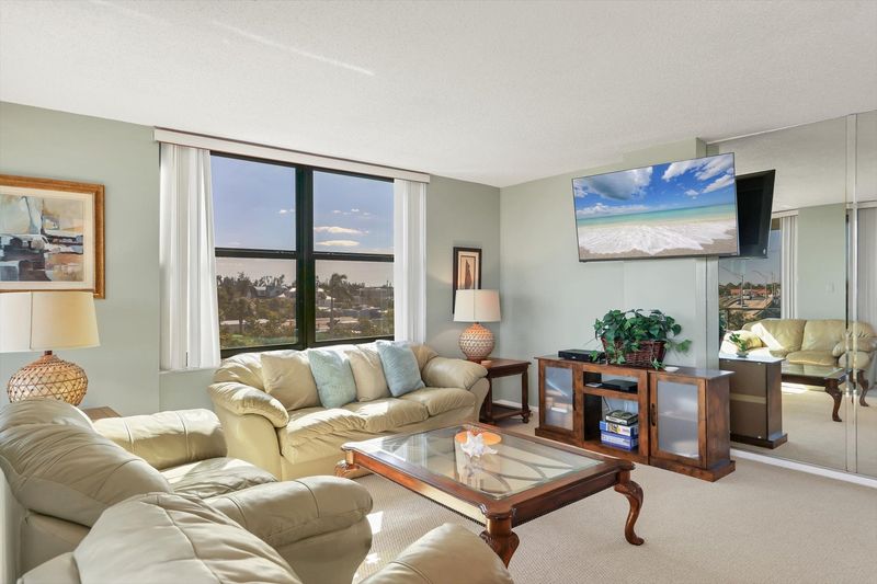 Living room/dining room combo with balcony access and view of Intracoastal Waterway