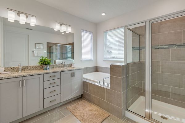 Beautiful ensuite bath has a dual vanity, walk-in shower and garden tub