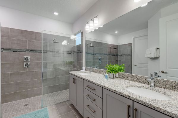 Ensuite bath with a large vanity and beautiful walk in shower