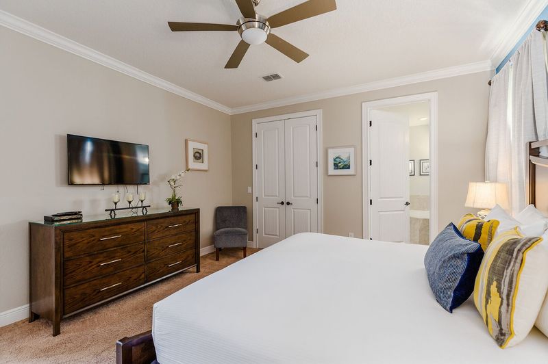 Spacious bedroom with a ceiling fan for optimal comfort